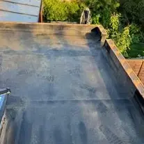 Finished flat roof with its covering turned up the low walls around the edge